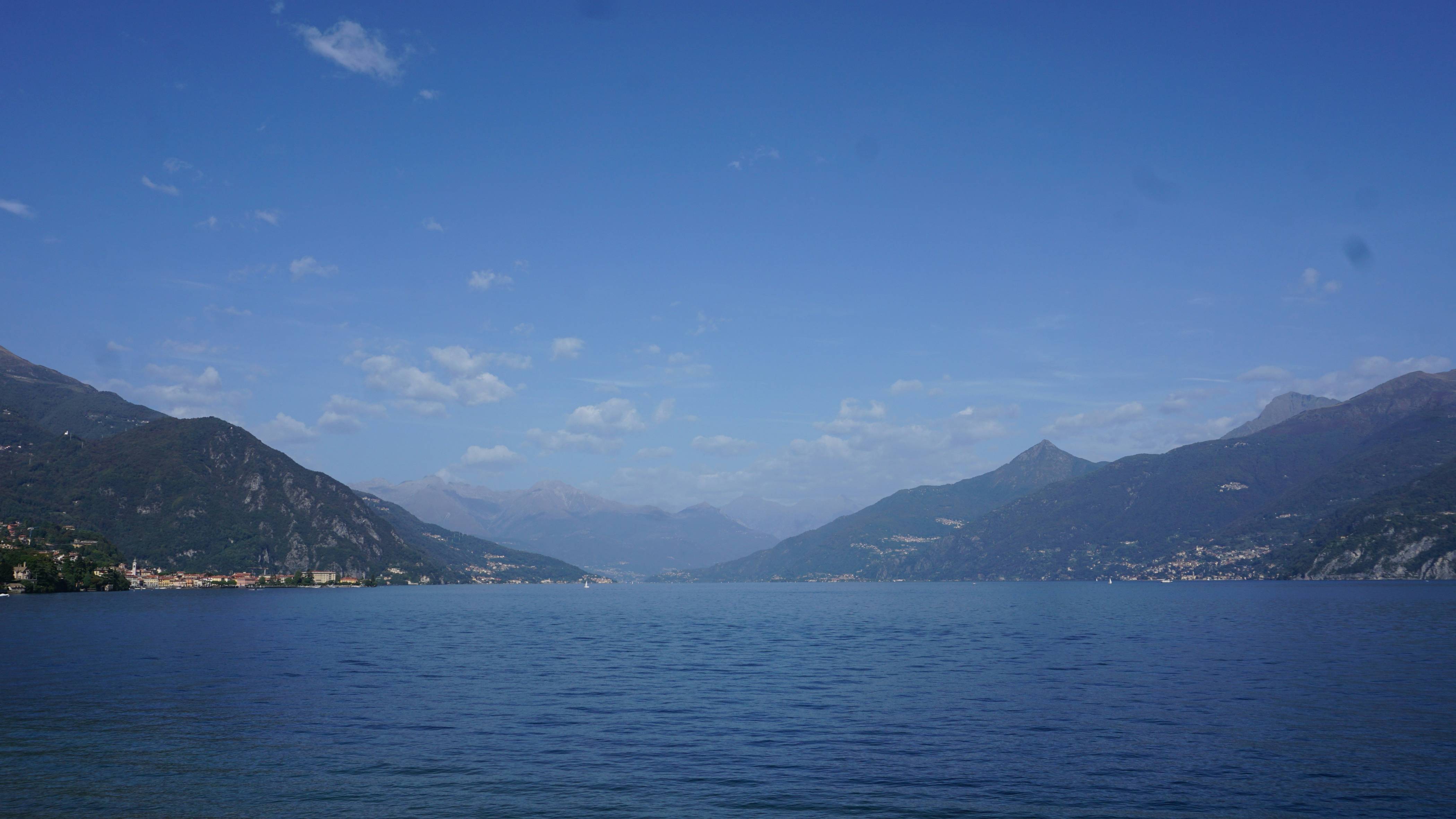A body of water with mountains in the background