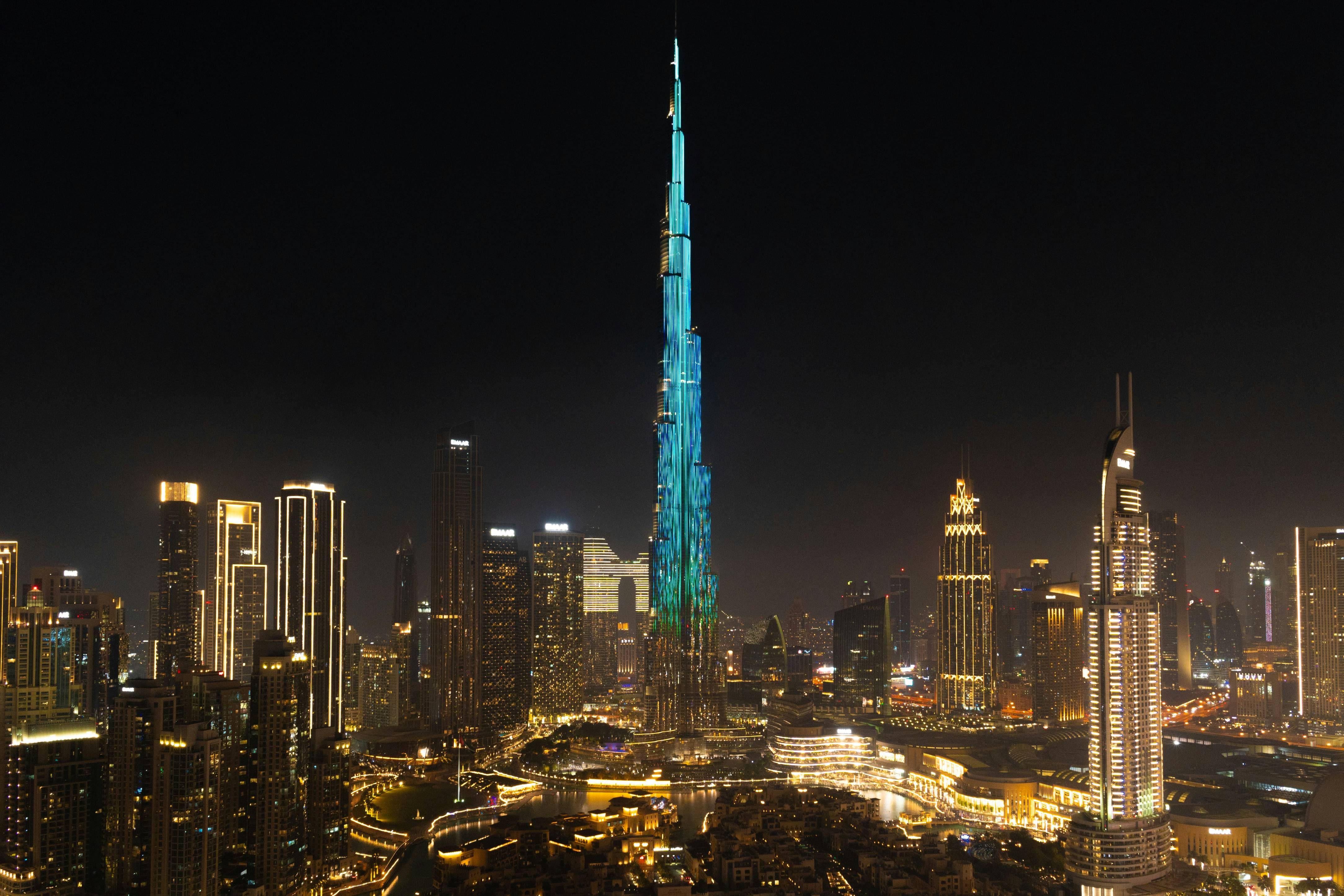 A very tall building towering over a city at night