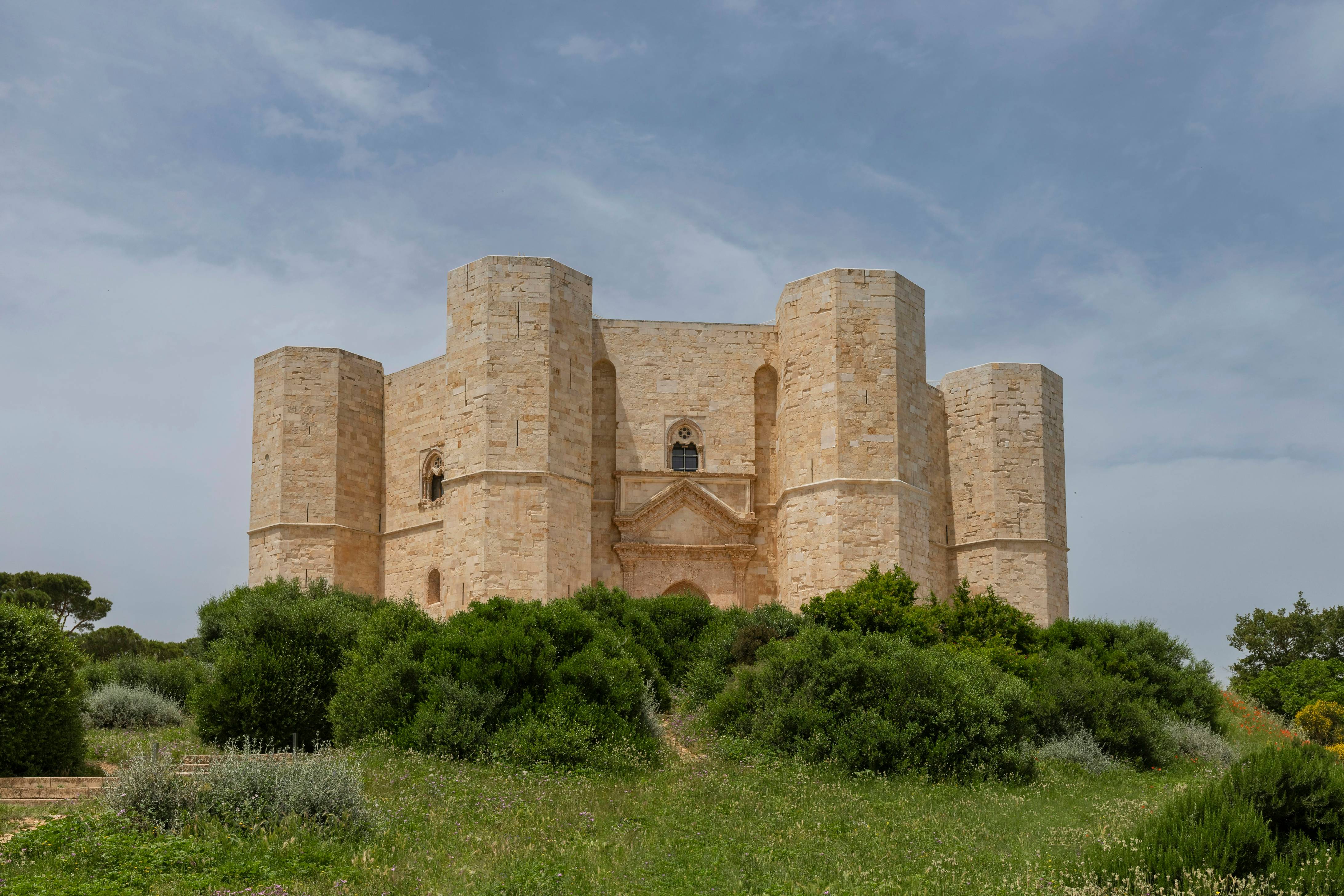 A large building with a tower in the middle of a field